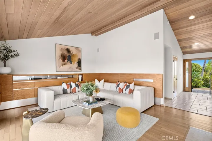 The main living area features vaulted ceilings, a two-sided fireplace, and custom built-ins—all designed with understated elegance.
