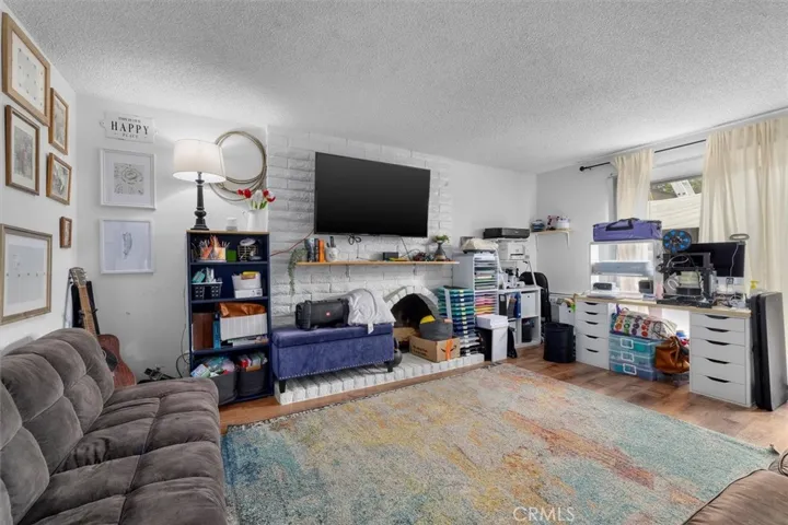 Unit C: Brick fireplace in living room