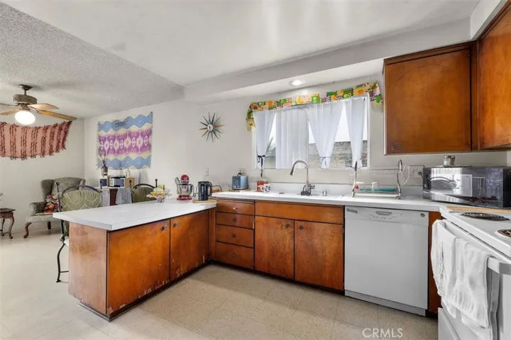 Unit D: Kitchen and dining space separated by bar top