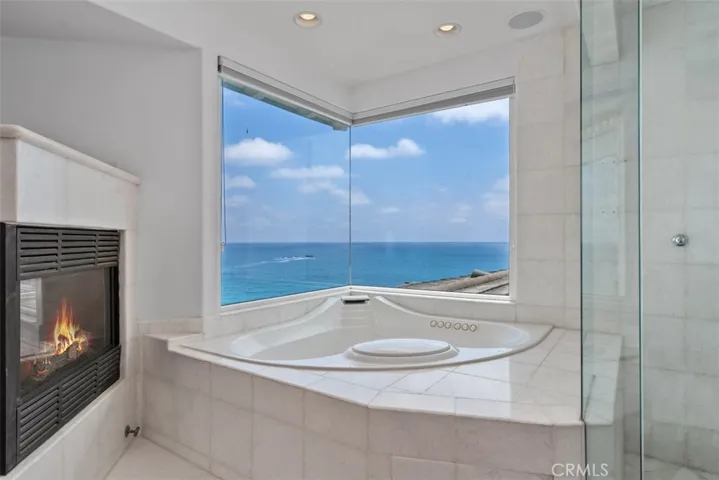 The views from the primary jetted tub.  Glass on glass windows for maximizing the views.  You have ocean views in the shower which as dual heads.