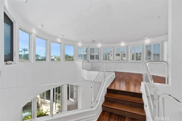 Just up the stairs to the turrett of the house.  Bright, light and windows with beautiful views.  This was used as an artists room and in the corner to the left is a sink. Plexi glass railings and windows on the stairs and landing have built-in lighting at the base.