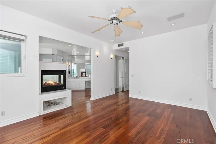 Mirrors in the bathroom from vanity to ceiling.