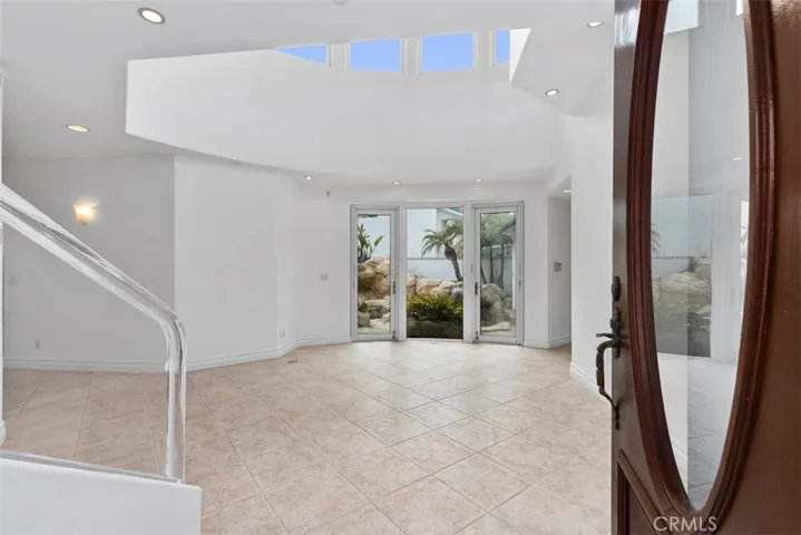 Main enterance of the house with extremely large open area overlooking the private and tropical garden and rock pool area.  At one time this is where the baby grand piano was with the open ceiling and windows it was an ideal location for music that could fill the house.
