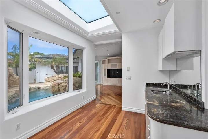 Just to the other side of the kitchen is a great dinnette area overlooking the pool and equiped with a full wet bar, plenty of cabinets, icemaker and bar refrigerator.  The door leades to the private pool area or staight ahead one of the two family rooms with a fireplace.