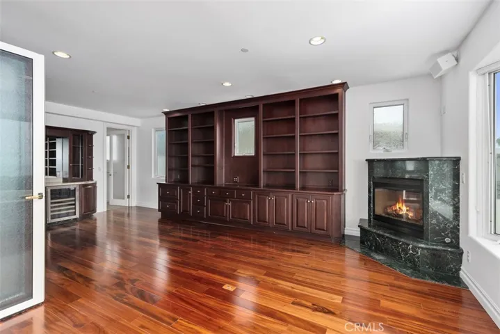 Ocean view bedroom/office/library with granite fireplace.  This room has a built-in bed, desk, wine refrigerator, sink and custom built-in on three walls.  It too has a private bathroom and custom frosted glass doors the accordian doors that can be opened or closed at different panels.