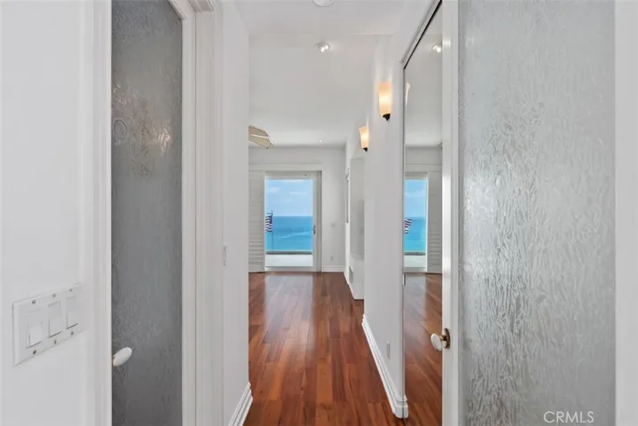 Enterance to the Primary Bedroom with frosted glass doors to keep all the rooms bright and light yet providing privacy.  Upstairs are only the turrett room and the primary bedroom, bathroom.