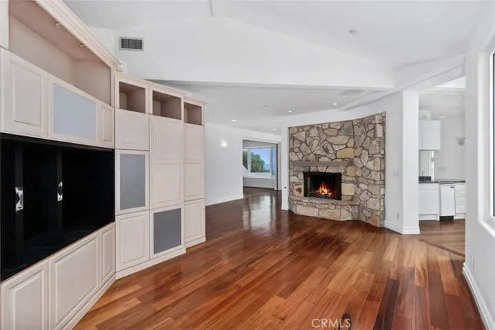 Family room with built-in cabinets and fireplace, also have a view of pool side. Another one of 4 indoor fireplaces.