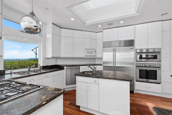 Uncut beautiful granite countertop. SubZero double door refrigerator/freezer, Boshe dishwasher, oven, microwave, 5 burner gas Thermador, vegetable in the center island with trash pull out in the center island, 2 full lenght pull out spice racks, skylight over the island brings in wonderful lighting.