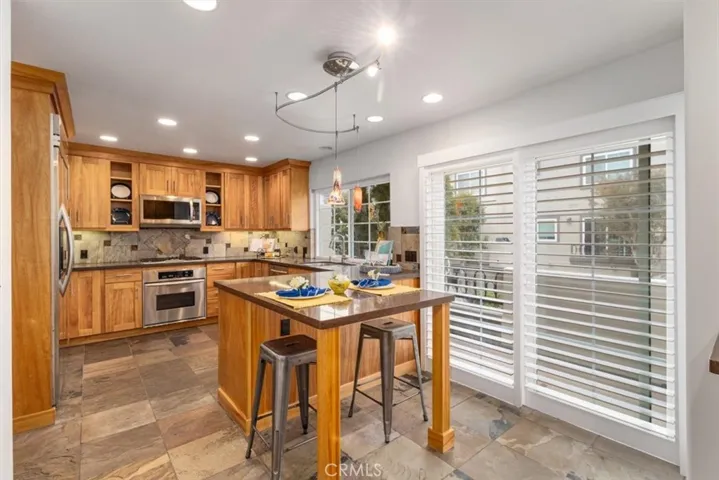 Cozy breakfast nook seats three—perfect for morning coffee, casual meals, or enjoying the coastal sunshine right from your kitchen.