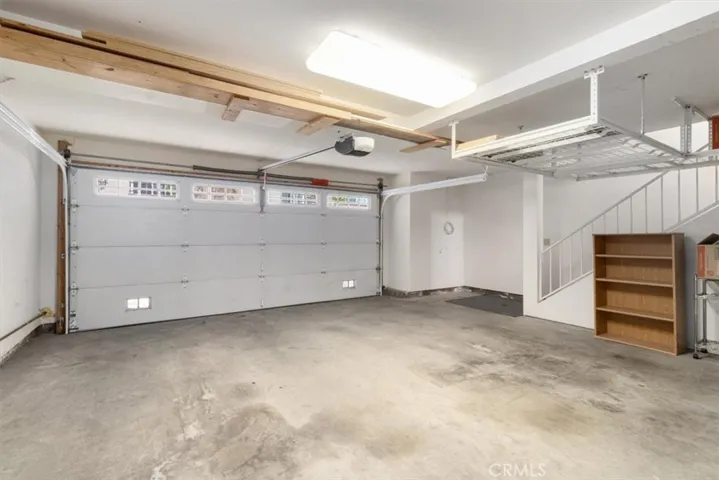 Well-organized two-car garage featuring overhead storage units—maximize space while keeping everything neat and easily accessible.