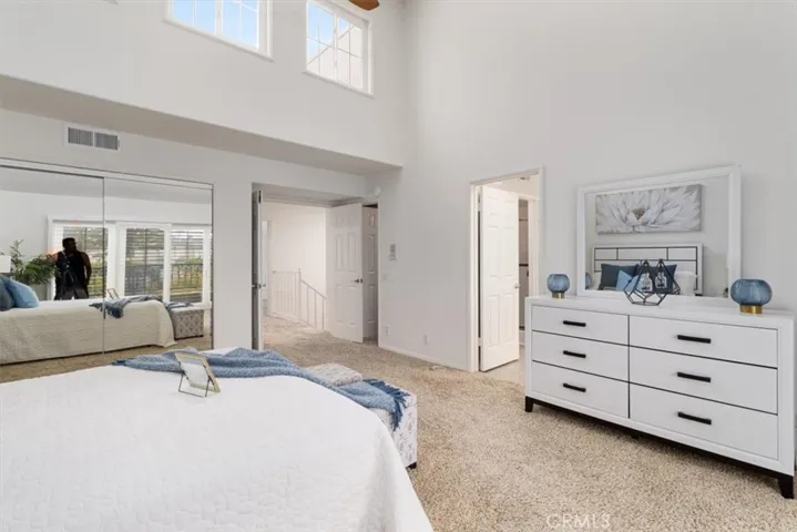 Serene primary bedroom with a sliding glass door that opens to a sunny private patio—enjoy peaceful views and gentle coastal breezes right from your room.