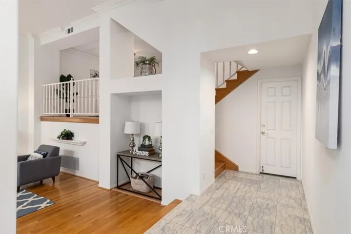 Step into coastal elegance—this inviting entryway features gleaming marble floors and a light, bright beachy vibe that sets the tone for stylish seaside living.