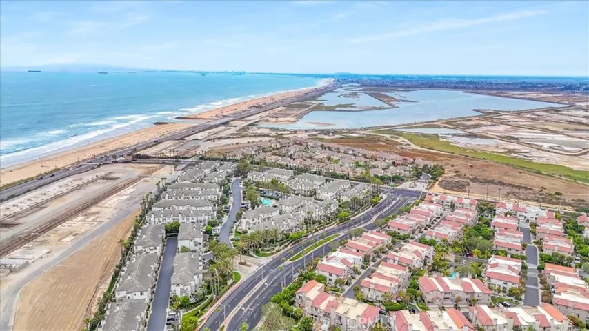 Aerial view of the Bolsa Chica Wetlands and Harriet Wieder Nature Park—just a short walk from your condo, offering acres of untouched beauty for exploring, dog walking, and enjoying peaceful moments in nature.
