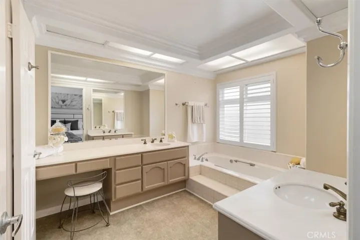 Luxurious primary bathroom featuring a relaxing spa tub, dual sinks, and a spacious walk-in shower—your personal spa-like retreat.