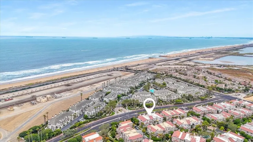 Aerial view of your coastal retreat—just a 6-minute walk to the beach! Nestled in a prime location, this condo offers the perfect blend of convenience, comfort, and seaside living.
