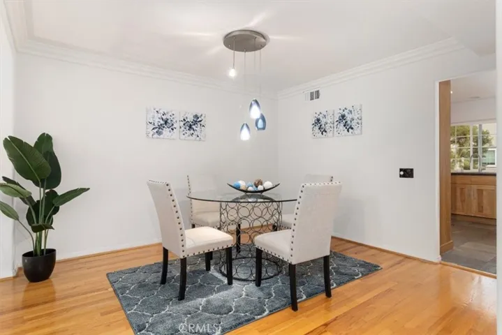 Elegant and inviting formal dining room with a warm ambiance and a beautiful view overlooking the spacious living room—perfect for hosting and entertaining.