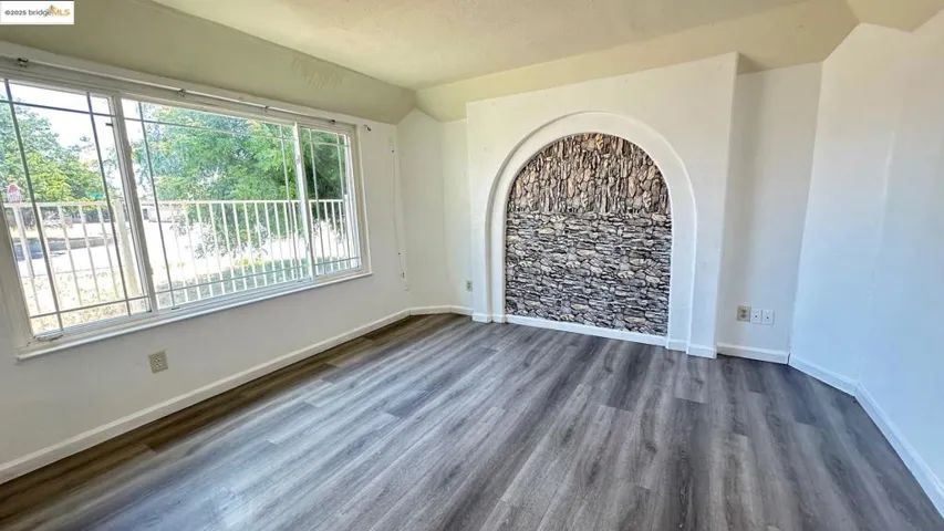 Spare room featuring wood finished floors and baseboards