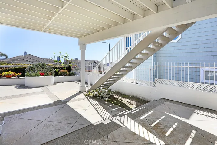 Stairs from patio up to the deck