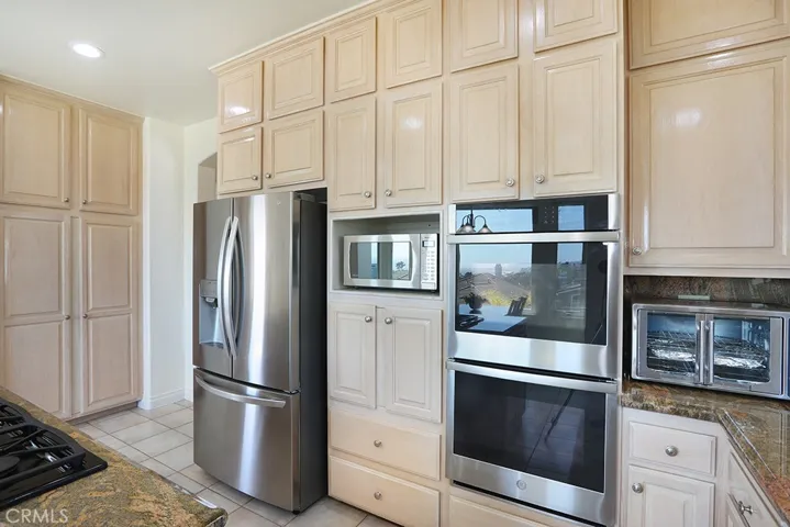 Chef's kitchen with double ovens, refrigerator, microwave