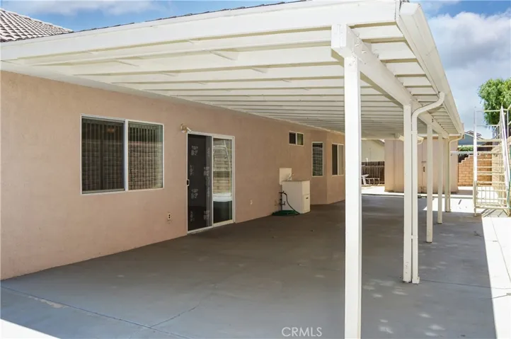 Expansive Covered Patio Addition and Abundant Concrete Create a Shady, Easy-Care Backyard Space
