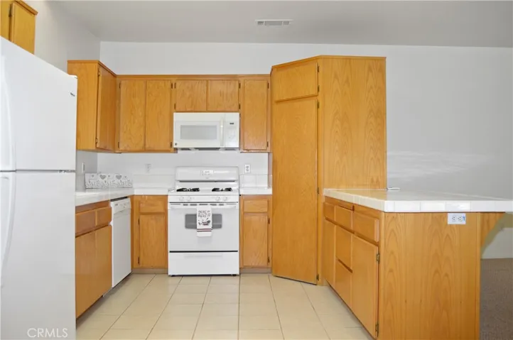 Efficient, U-Shaped Kitchen with Gas Range, Microwave, Dishwasher, Refrigerator Included, Large Pantry, & Skylight