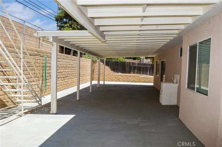 Expansive Covered Patio Addition and Abundant Concrete Create a Shady, Easy-Care Backyard Space
