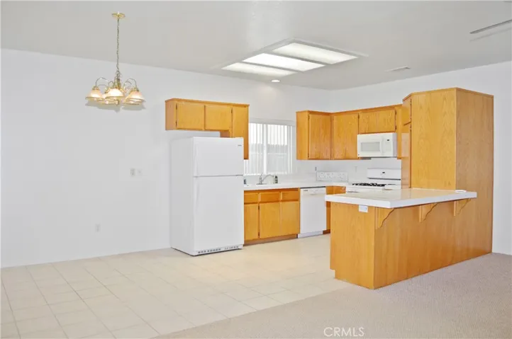 Dining Open to Kitchen and Living Area with Back Patio Views