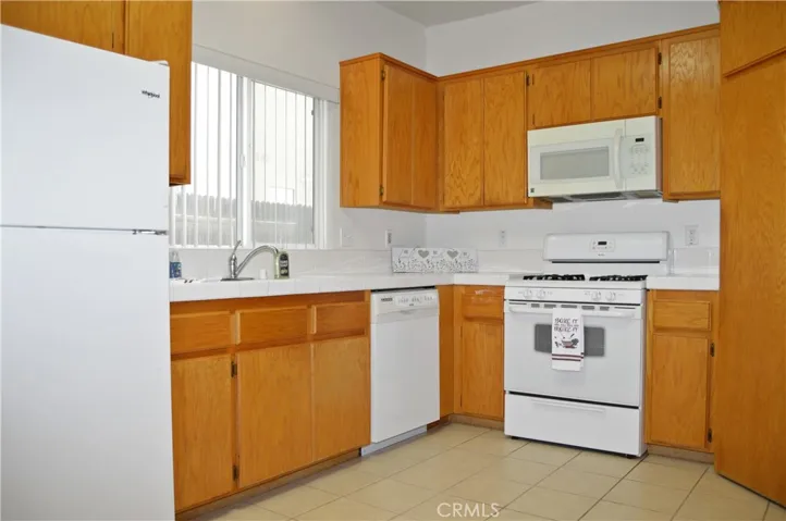 Efficient, U-Shaped Kitchen with Gas Range, Microwave, Dishwasher, Refrigerator Included, Large Pantry, & Skylight