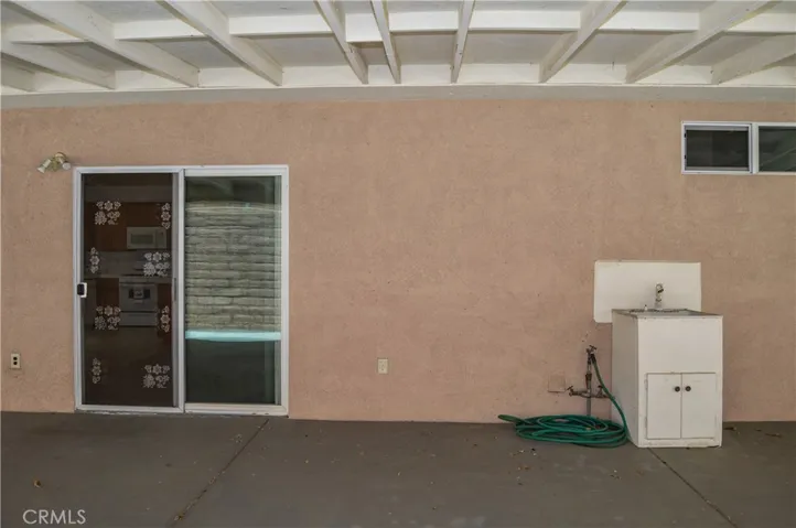 Expansive Covered Patio Addition and Abundant Concrete Create a Shady, Easy-Care Backyard Space