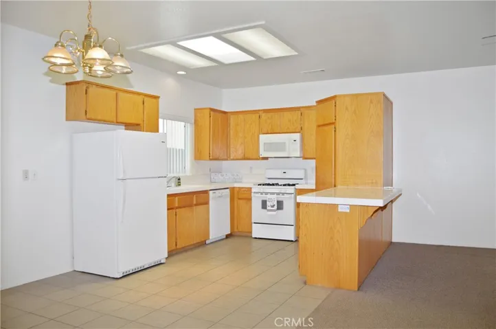 Efficient, U-Shaped Kitchen with Gas Range, Microwave, Dishwasher, Refrigerator Included, Large Pantry, & Skylight