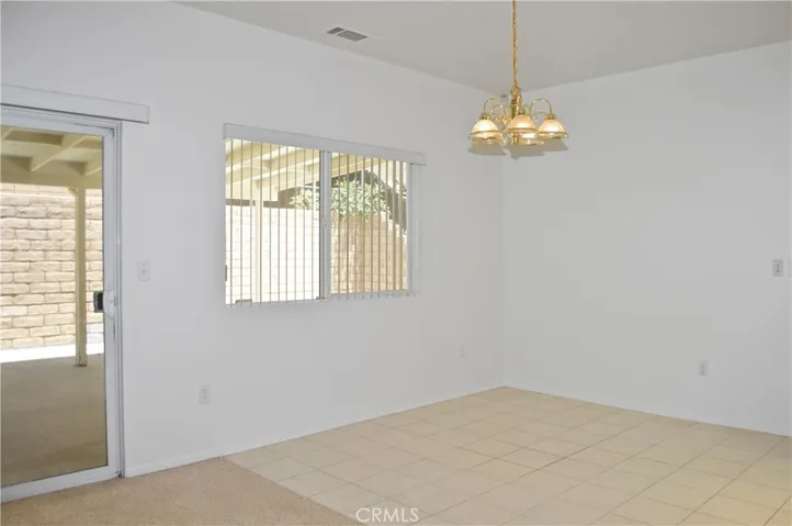 Dining Open to Kitchen and Living Area with Back Patio Views