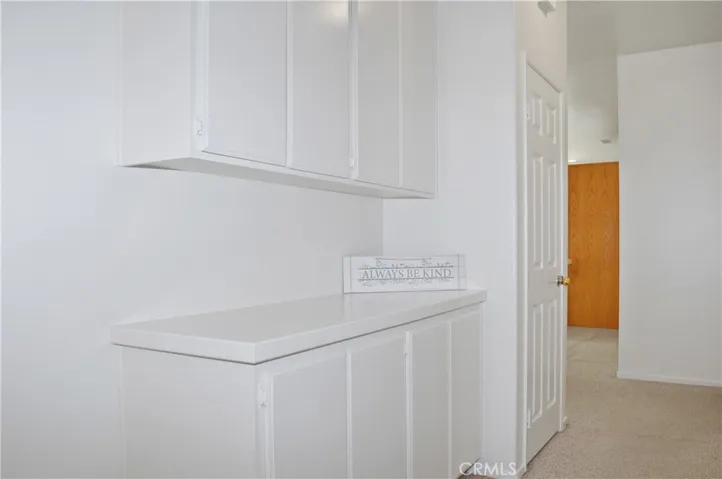Hall with Alarm, Coat Closet, and Linen Cabinets