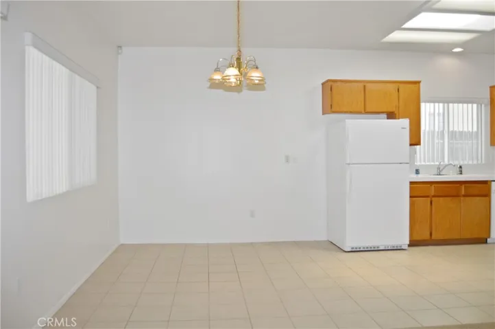 Dining Open to Kitchen and Living Area with Back Patio Views