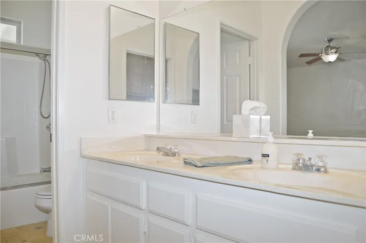 Main Bath with Dual Sinks, Privacy Door to Water Closet with Enclosed Tub/Shower Combo and Toilet