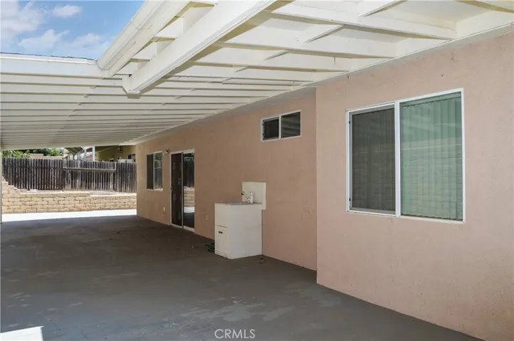 Expansive Covered Patio Addition and Abundant Concrete Create a Shady, Easy-Care Backyard Space
