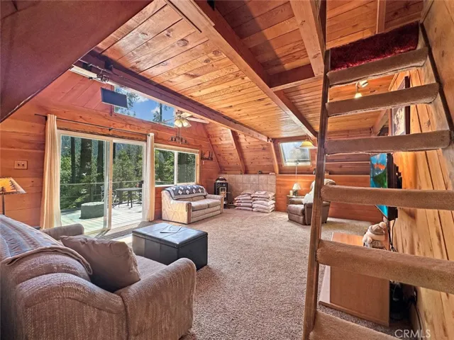 Cozy Living Room with beamed ceiling, pellet stove and beautiful mountain views.