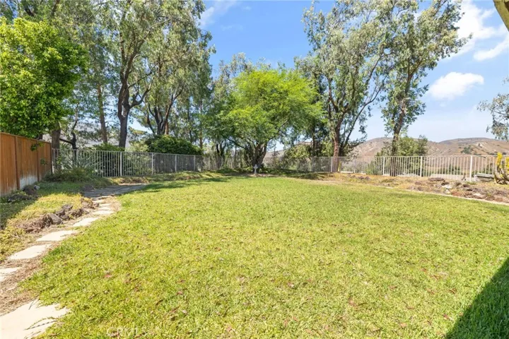 Large yard offers room for a pool, kids play area, and parties.