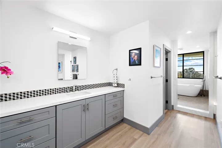 Master Bathroom overlooking the patio with view, boasts dual sinks, walk-in shower and a soaking tub.