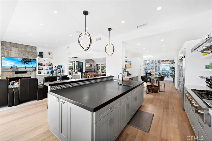 Tastefully remodeled kitchen with high-end appliances, designer backsplash, cabinetry, counter-top and light fixtures.