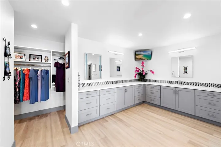 Master bathroom offers ample cabinets, dual sinks, large walk-in shower and tub.