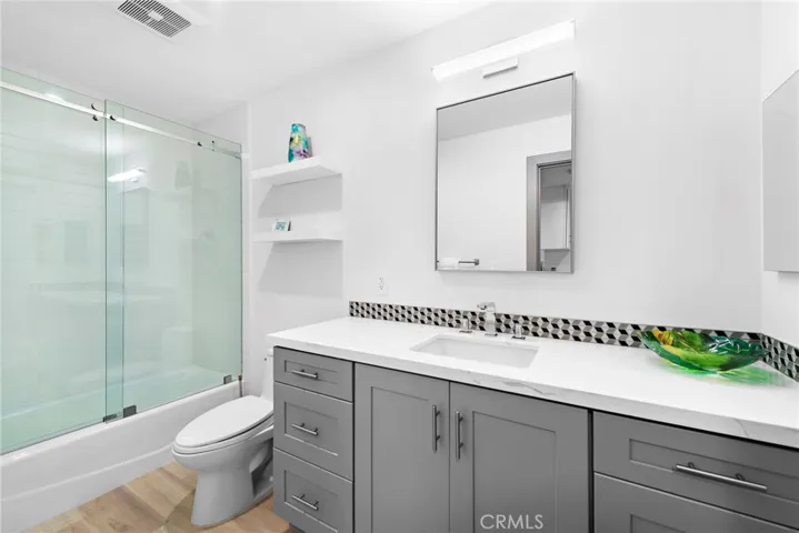 Lower level bathroom is adjacent to the laundry room.