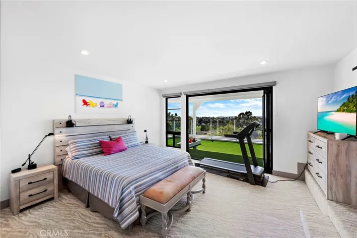 Master suite with an added walk-in closet opens out to the back patio through an updated fold up doors to enjoy the panoramic view.