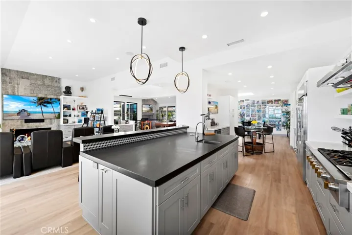 Tastefully remodeled kitchen with high-end appliances, designer backsplash, cabinetry, counter-top and light fixtures.