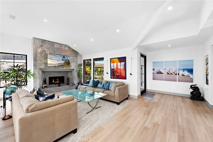Formal living room with a fireplace and view.