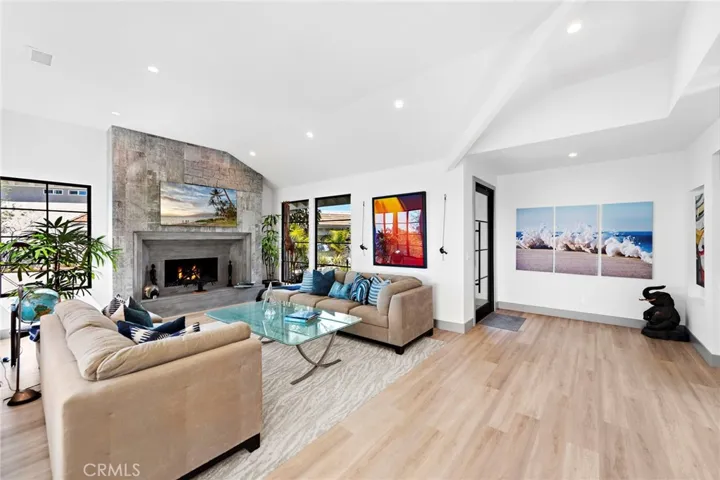 Formal living room with a fireplace and view.
