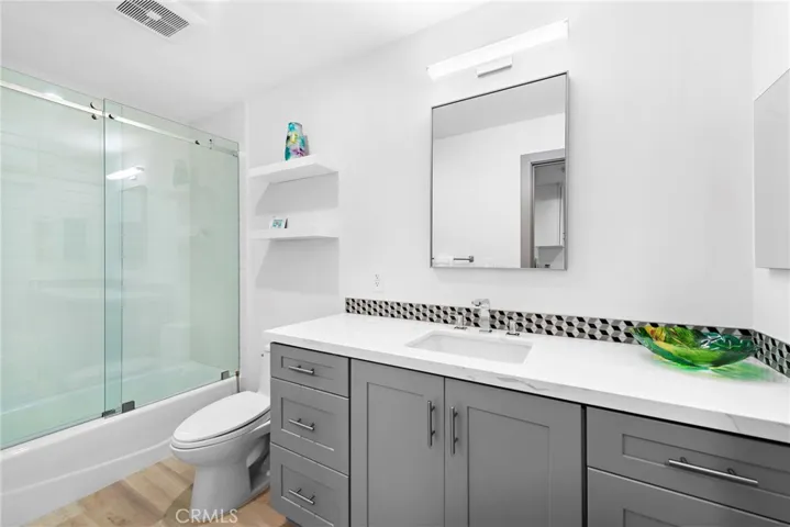 Lower level bathroom is adjacent to the laundry room.