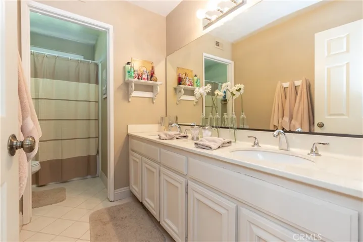 Full hall bath upstairs with dual vanity.