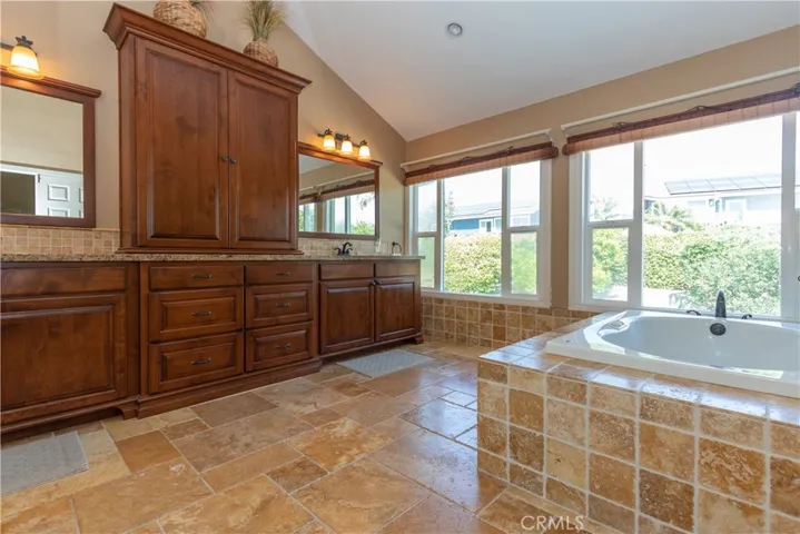 Updated primary bath with soaking tub and dual vanity.