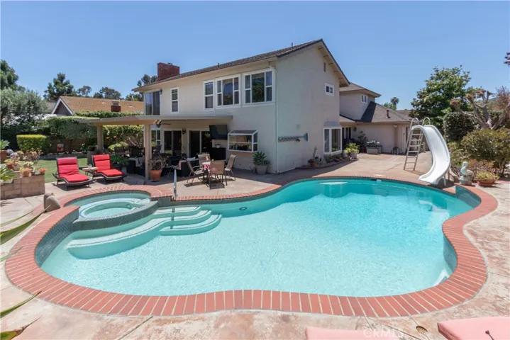 Fabulous backyard with pool and spa, covered patio and turf.
