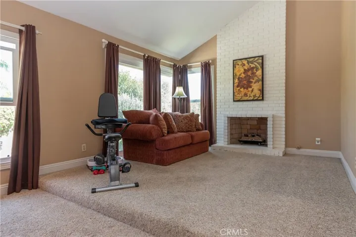 Primary suite bonus  area with a fireplace.